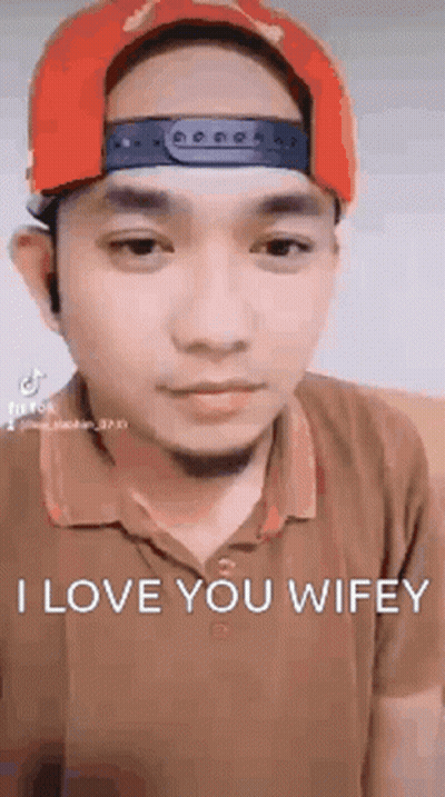 Man In Red Hat And Brown Shirt Making Funny Face GIF