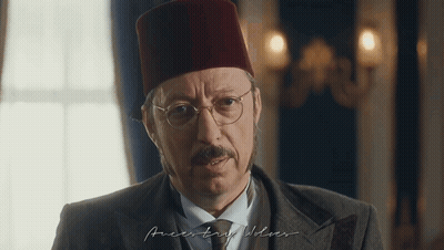 Man In Red Hat And Glasses Looking At Camera GIF