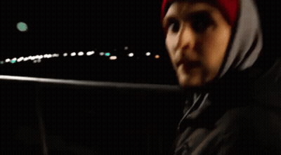Man In Red Hat And Hooded Jacket In Dark GIF