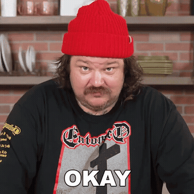 Man in Red Hat and Okay Shirt