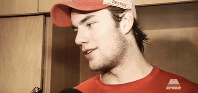 Man In Red Hat And Red T-Shirt Talking To Microphone GIF