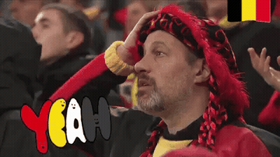 Man In Red Hat And Scarf Sitting In Crowd Saying Yeah GIF