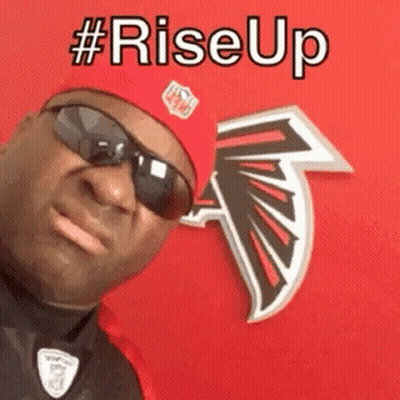 Man In Red Hat And Sunglasses In Front Of Falcons Logo GIF