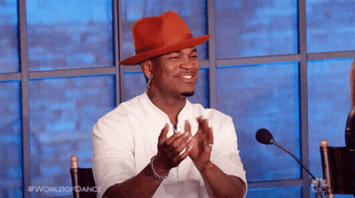 Man In Red Hat Applauding At Microphone GIF