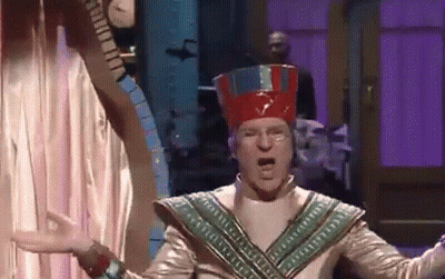 Man In Red Hat Costume Before Purple Curtain GIF