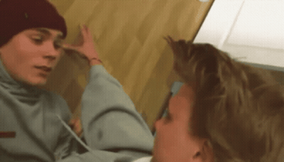 Man In Red Hat Holding Another Man's Head GIF