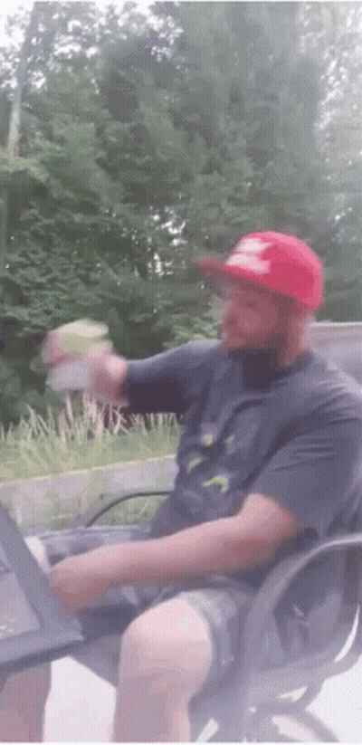 Man In Red Hat Holding Bottle GIF