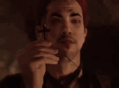 Man In Red Hat Holding Cross GIF