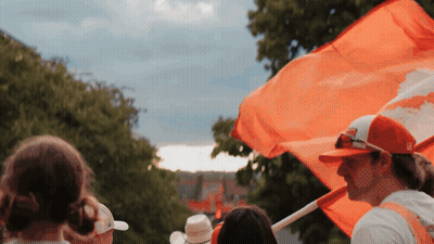 Man In Red Hat Holding Orange Flag GIF