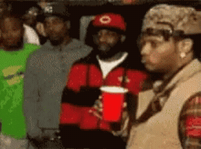 Man In Red Hat Holding Red Cup GIF