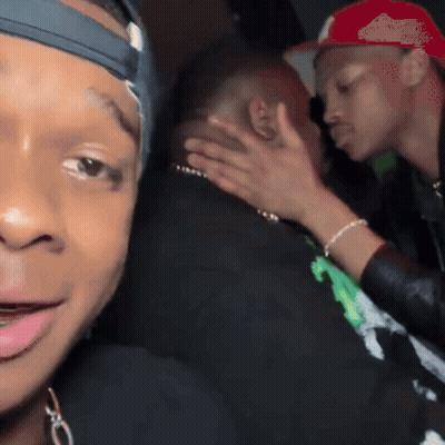 Man In Red Hat Petting Another Man's Face GIF