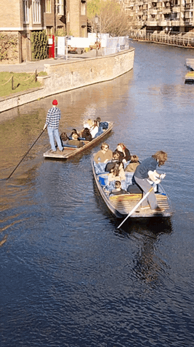 Man In Red Hat Pulling Boat Full Of People GIF
