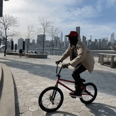 Man in Red Hat Riding Bike