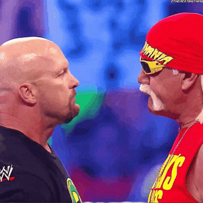 Man In Red Hat Saying Hulk Hogan Next To Another Man GIF