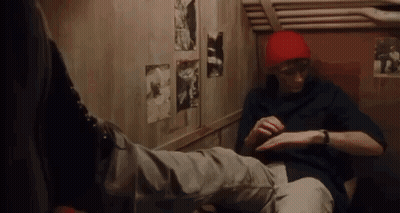 Man In Red Hat Sitting Next To Another Man GIF