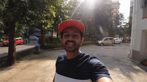 Man in Red Hat Taking Selfie