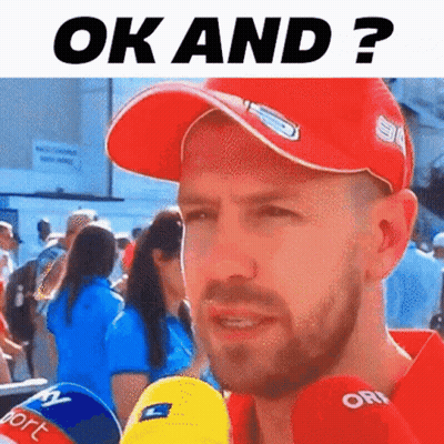 Man In Red Hat Talking Into Microphone GIF
