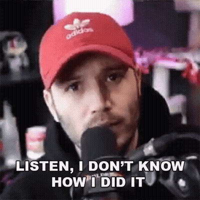 Man In Red Hat Talking Into Microphone Saying Listen I Don't Know How I Did GIF