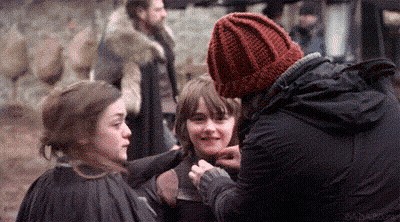 Man In Red Hat Talking To Two Girls On Movie Set GIF