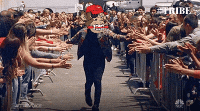 Man In Red Hat Walking Through Crowd With Word Tribe GIF