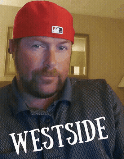 Man in Red Hat Wearing Westside Shirt