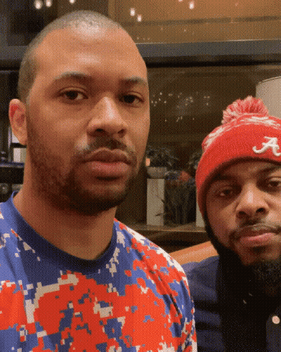 Man In Red Hat With Letter A Standing Next To Another Man GIF