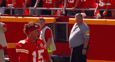 Man In Red Headband Standing Before Crowd GIF