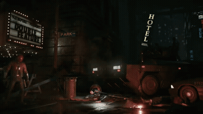 Man In Red Helmet And Leather Jacket Holding Two Guns GIF