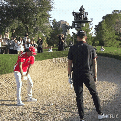 Man In Red Hitting Golf Ball GIF