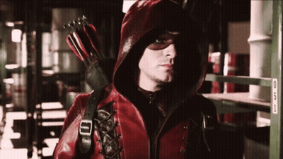 Man In Red Hooded Jacket Holding Red Arrow GIF