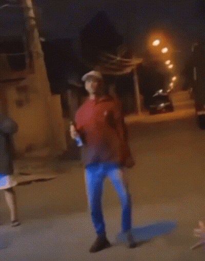 Man In Red Hoodie And Blue Jeans Holding Beer GIF