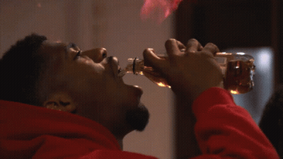 Man In Red Hoodie Drinking From Bottle With Flames GIF
