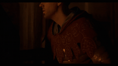 Man In Red Hoodie Holding Candle In Dark GIF