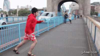 Man In Red Hoodie Running On Bridge GIF