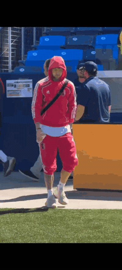 Man In Red Hoodie Walking On Field GIF