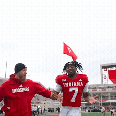 Man In Red Indiana Jersey Held By Another Man GIF