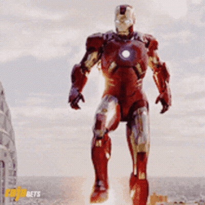 Man In Red Iron Man Suit In Front Of Cloudy Sky GIF