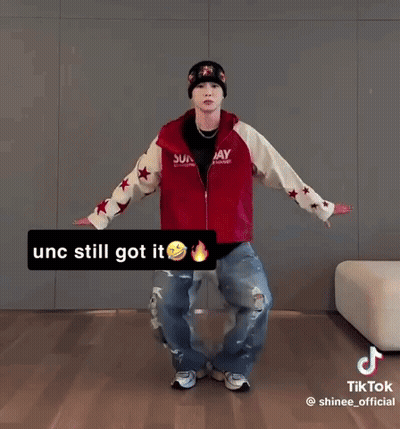 Man In Red Jacket And Beanie Dancing GIF