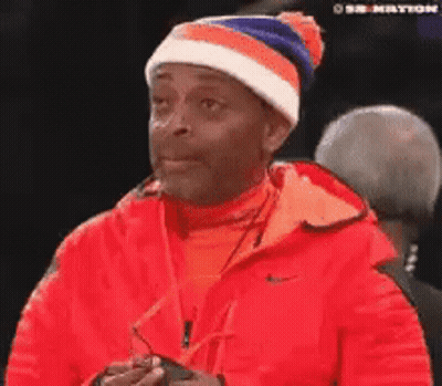 Man In Red Jacket And Beanie Looking GIF