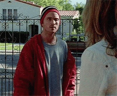 Man In Red Jacket And Beanie Next To Woman GIF