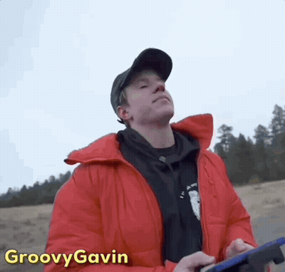 Man In Red Jacket And Black Hat Holding Tablet GIF