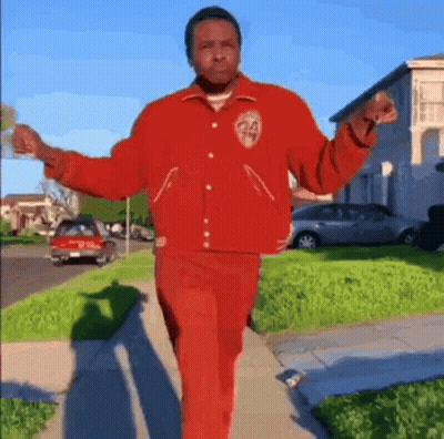 Man In Red Jacket And Pants Walking GIF