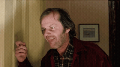 Man In Red Jacket And Plaid Shirt Standing In Doorway GIF