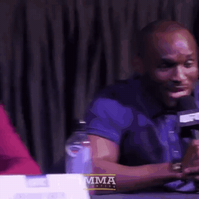Man In Red Jacket And Tie At Desk GIF