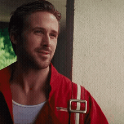 Man In Red Jacket And White Tank Top Smiling Next To Wall GIF
