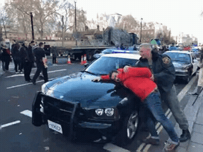 Man In Red Jacket Arrested By Police Officer GIF