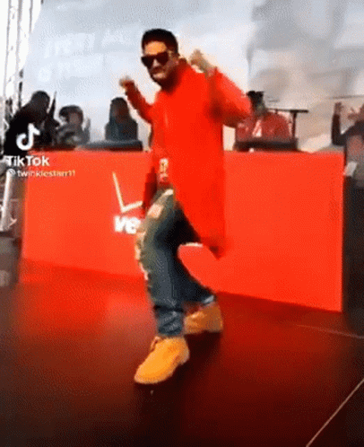 Man In Red Jacket Dancing At Verizon Sign GIF