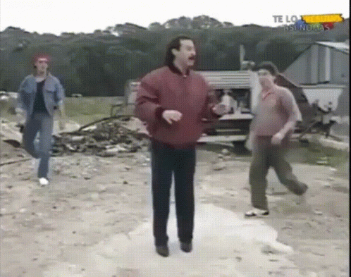 Man In Red Jacket Dancing In Front Of Te Lo As Nuevas Sign GIF