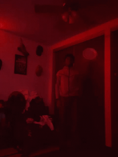 Man In Red Jacket Dark Room Ceiling Fan GIF
