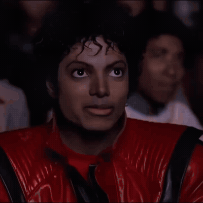 Man In Red Jacket Eating Popcorn In Theater GIF